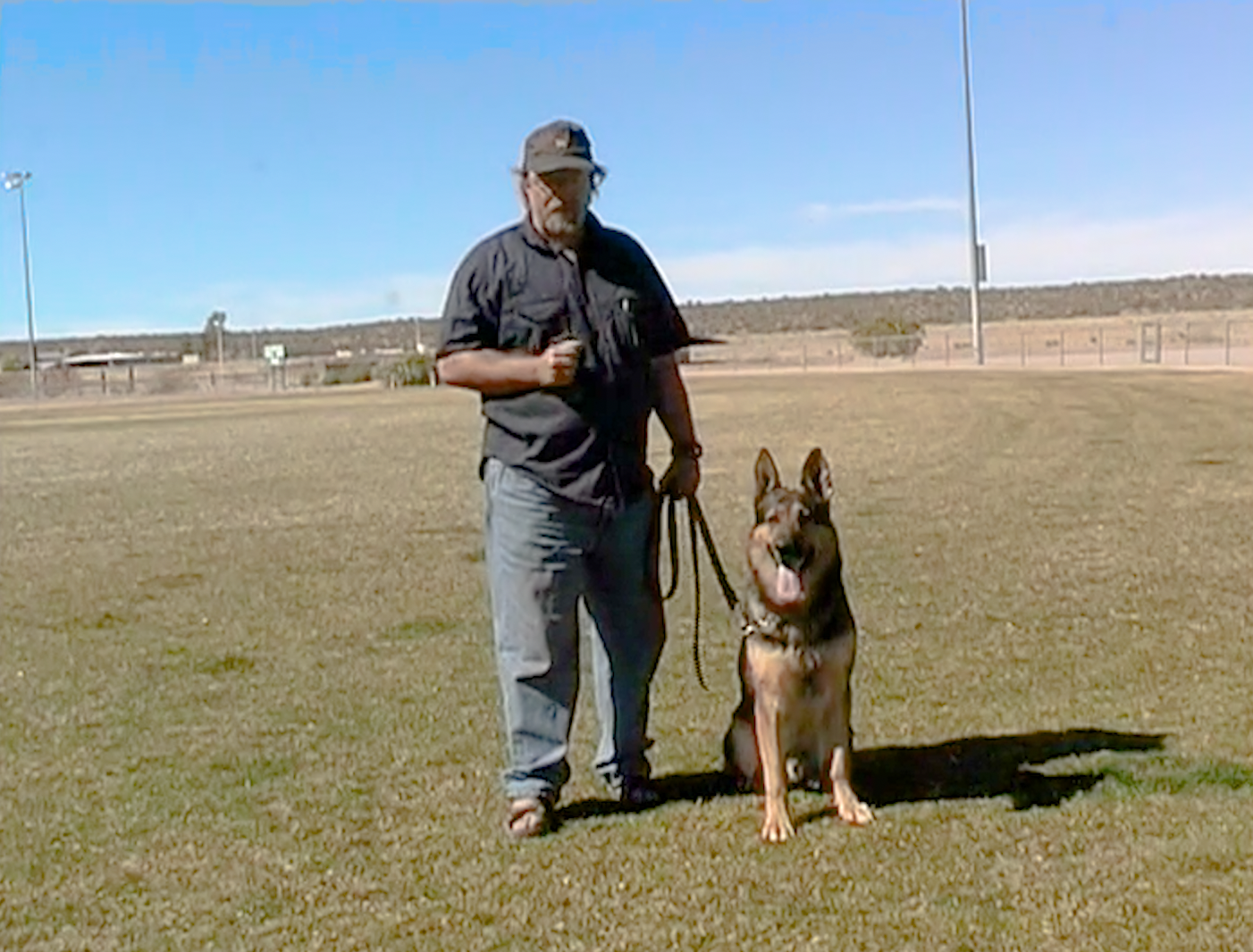Hans teaching obedience with a German Shepherd on the training field